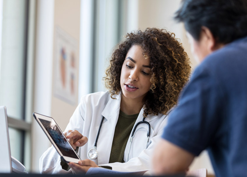 Female-doctor-using-a-tablet-to-discuss-treatment-options-at-a-varicose-veins-center-in-Las-Vegas