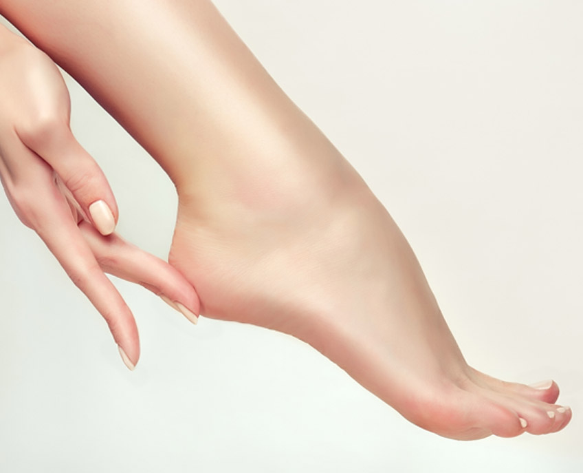 Woman’s-hand-touching-heel-after-successful-treatment-by-a-spider-veins-doctor-in-Las-Vegas